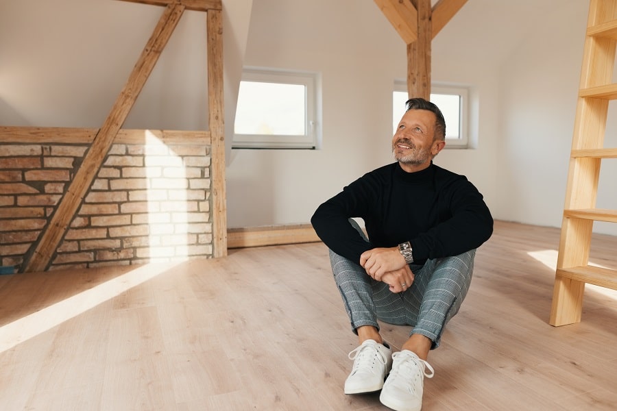 homeowner sitting in a newly converted attic or loft